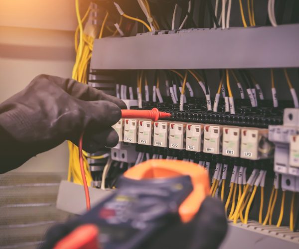 Close-up hand of electrical engineering using measuring to checking electricity.